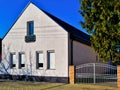 modern white stucco house exterior elevation. small French balcony and glass door Royalty Free Stock Photo