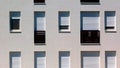 white stucco facade detail with windows and french balcony. exterior elevation. Royalty Free Stock Photo