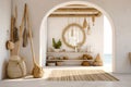 White stucco walls and arched doorway in farmhouse hallway. Rustic style interior design of boho entrance hall in country house.