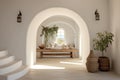 White stucco walls and arched doorway in farmhouse hallway. Rustic style interior design of boho entrance hall in country house