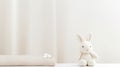 A white stuffed rabbit next to a bed, AI