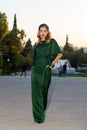 White stunning female model is posing outside wearing a green dress and accessories Royalty Free Stock Photo