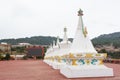 White stupas with golden tops and part of the the buddhist Sakya Monastery