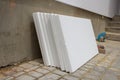 White styrofoam near the house,styrofoam sheets stacked to the wall for repair and insulation of the facade of the house Royalty Free Stock Photo