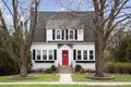 A white suburban home with a red front door. Royalty Free Stock Photo