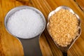 White sugar and cane in the home kitchen. Sweetener for kitchen dishes on a wooden table