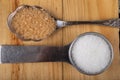 White sugar and cane in the home kitchen. Sweetener for kitchen dishes on a wooden table