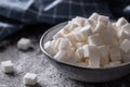 White sugar cubes in a blue bowl on the table Royalty Free Stock Photo