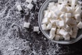 White sugar cubes in a blue bowl on the table Royalty Free Stock Photo