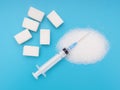 White sugar, cubes and granulated, on bright colourful background with syringe. Unhealthy eating, diabetes health risks Royalty Free Stock Photo