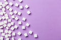 White sugar cubes on magenta background