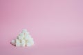 White sugar cubes on a pink background