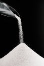 white sugar falling from metal scoop on pile i Royalty Free Stock Photo