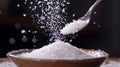 White Sugar Pouring from Spoon into Brown Bowl Royalty Free Stock Photo