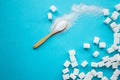 White sugar with spoon on blue background. Royalty Free Stock Photo