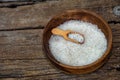 white sugar in wooden bowl, wooden scoop on old wooden background Royalty Free Stock Photo