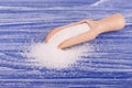 White sugar on wooden spoon on blue wooden background. Royalty Free Stock Photo