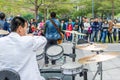 A white suit drumer of a Shenzhen local street band performing at the Central park of Shenhzhen, Guangdong, China