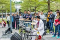 A white suit drumer of a Shenzhen local street band performing at the Central park of Shenhzhen, Guangdong, China