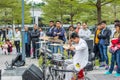 A white suit drumer of a Shenzhen local street band performing at the Central park of Shenhzhen, Guangdong, China