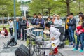 A white suit drumer of a Shenzhen local street band performing at the Central park of Shenhzhen, Guangdong, China