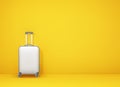 White suitcase on yellow background with copy space