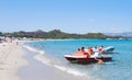 White summer beach with blue sea, people, boat and pedal