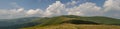 White summer clouds above mountain meadows