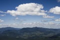 White summer clouds overt the mountains Royalty Free Stock Photo