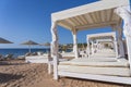 White sun canopy with mattress on luxury sand beach in tropical resort in Red Sea coast in Egypt, Africa Royalty Free Stock Photo