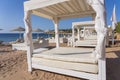 White sun canopy with mattress on luxury sand beach in tropical resort in Red Sea coast in Egypt, Africa Royalty Free Stock Photo