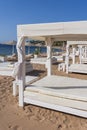 White sun canopy with mattress on luxury sand beach in tropical resort in Red Sea coast in Egypt, Africa Royalty Free Stock Photo