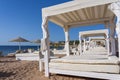 White sun canopy with mattress on luxury sand beach in tropical resort in Red Sea coast in Egypt, Africa Royalty Free Stock Photo