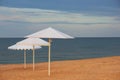 White sun umbrella on a sandy sea beach Royalty Free Stock Photo