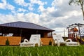 White sunbed in the garden with small house. Conctpt of summer rest outdoors