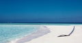 White sunbed near tropical calm beach with turquoise sea water and white sand. Maldives islands