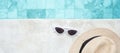 White sunglasses and hat near swimming pool in luxury hotel. Summer travel, vacation, holiday and weekend concept Royalty Free Stock Photo