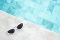 White sunglasses near swimming pool in luxury hotel. Summer travel, vacation, holiday and weekend concept Royalty Free Stock Photo
