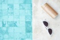 White sunglasses, sunscreen bottle and hat near swimming pool in luxury hotel. Summer travel, vacation, holiday and weekend Royalty Free Stock Photo