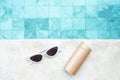 White sunglasses, sunscreen bottle and hat near swimming pool in luxury hotel. Summer travel, vacation, holiday and weekend Royalty Free Stock Photo