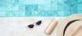 White sunglasses, sunscreen bottle and hat near swimming pool in luxury hotel. Summer travel, vacation, holiday and weekend Royalty Free Stock Photo