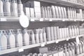 White supermarket shelf with cosmetics products, bottles, tubes, boxes, personal care products