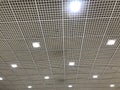 White suspended Grid False ceiling interiors view of an Shopping mall ceiling decoration work with down lights and can be used for