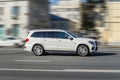 White SUV car in motion. Mercedes GLS fast speed drive on city road Royalty Free Stock Photo