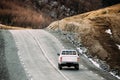 White SUV Car Moving On Mountain Road In Autumn Mountains Landsc Royalty Free Stock Photo