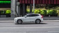 White SUV car Volvo XC90 fast drive on road in the city with blurred background Royalty Free Stock Photo