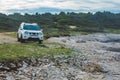 white suv between rocks. off road car travel concept Royalty Free Stock Photo