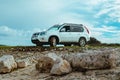 white suv between rocks. off road car travel concept Royalty Free Stock Photo