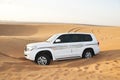 White SUV Toyota Land Cruiser in desert Royalty Free Stock Photo