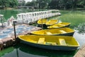 White Swan Pedal Boats and Yellow Rowing Boat pier in public park at Bangkok, Lumpini Park is an inner-city haven of tranquility Royalty Free Stock Photo